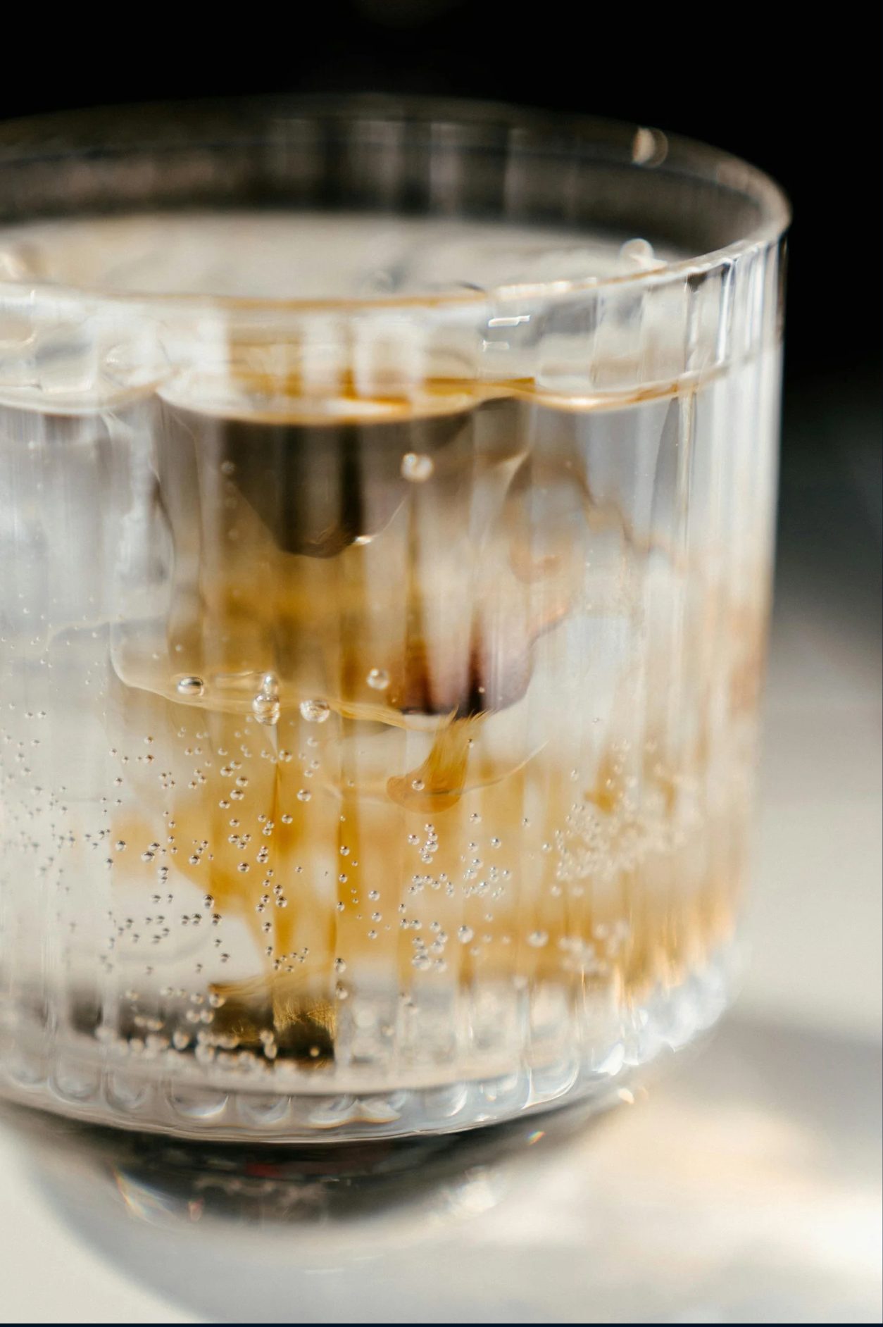 Opus Gin tamarind cocktail with ice in a ribbed glass
